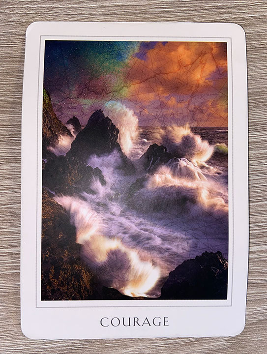 Courage oracle card - stormy waves crashing on a rocky shore.