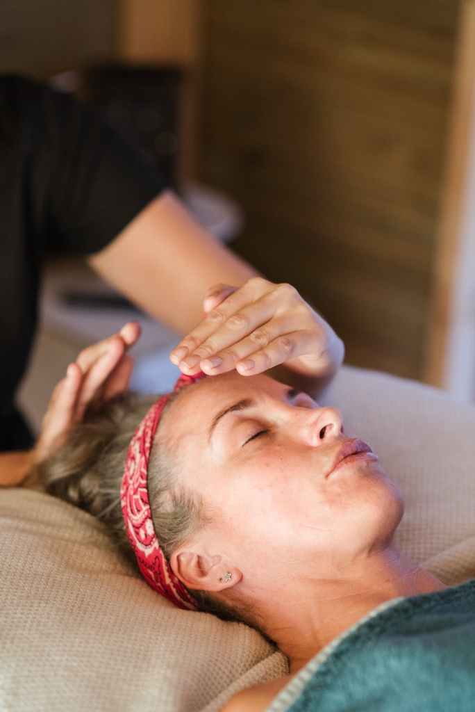 Person giving reiki to another person.